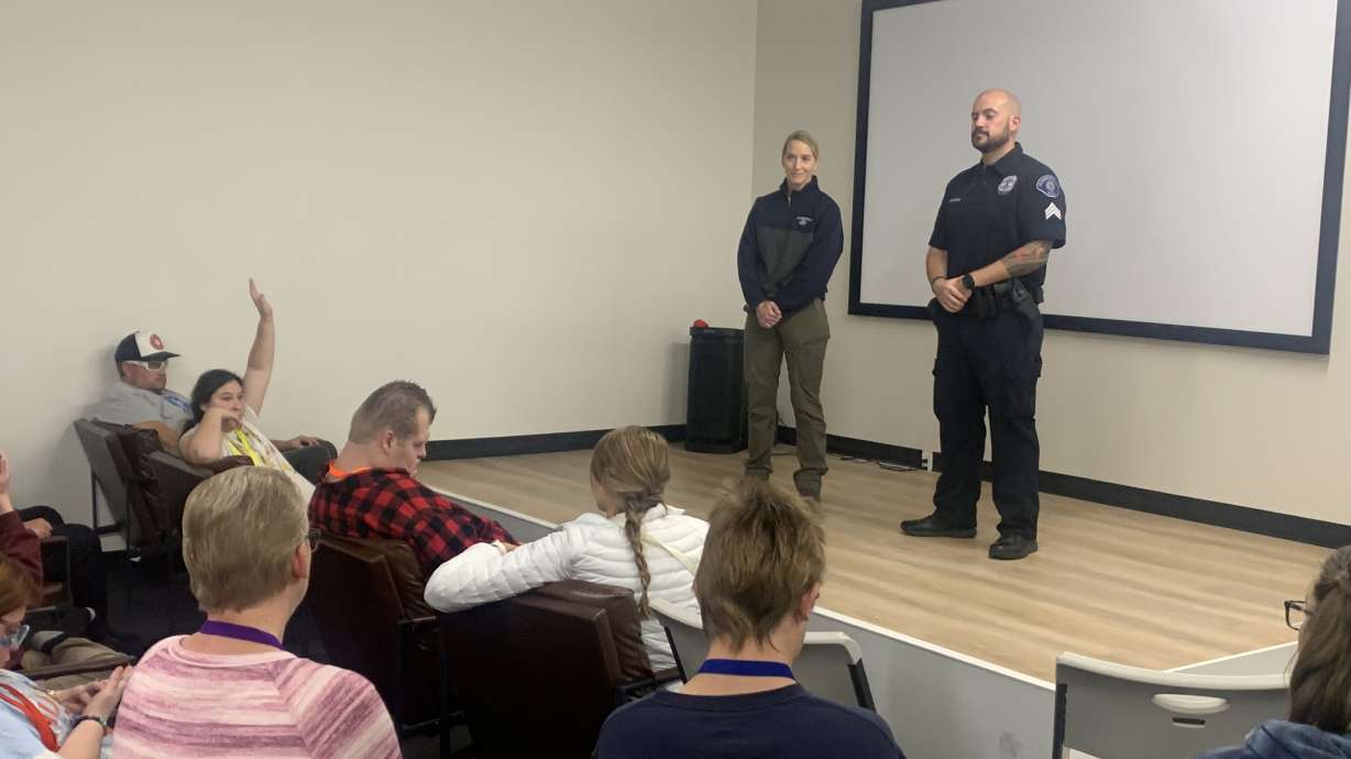 Police officers speak to Buddies4Life participants during a community safety event organized with Weber State students